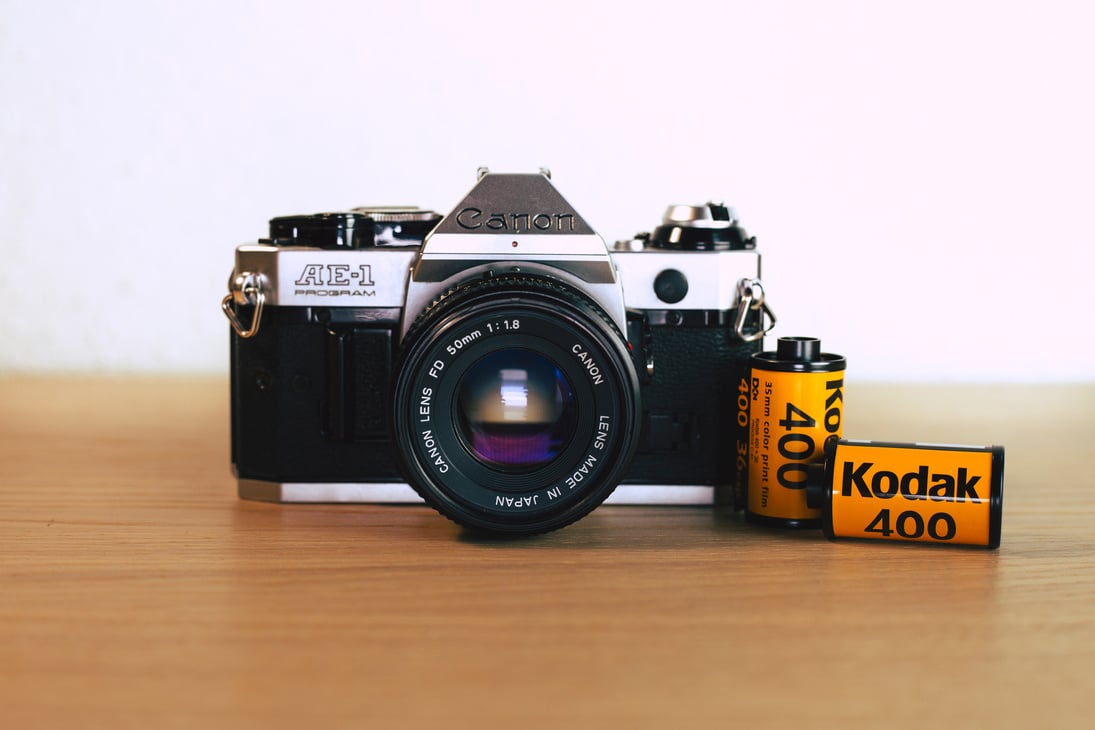 Close-up of an SLR Camera and Rolls of Film